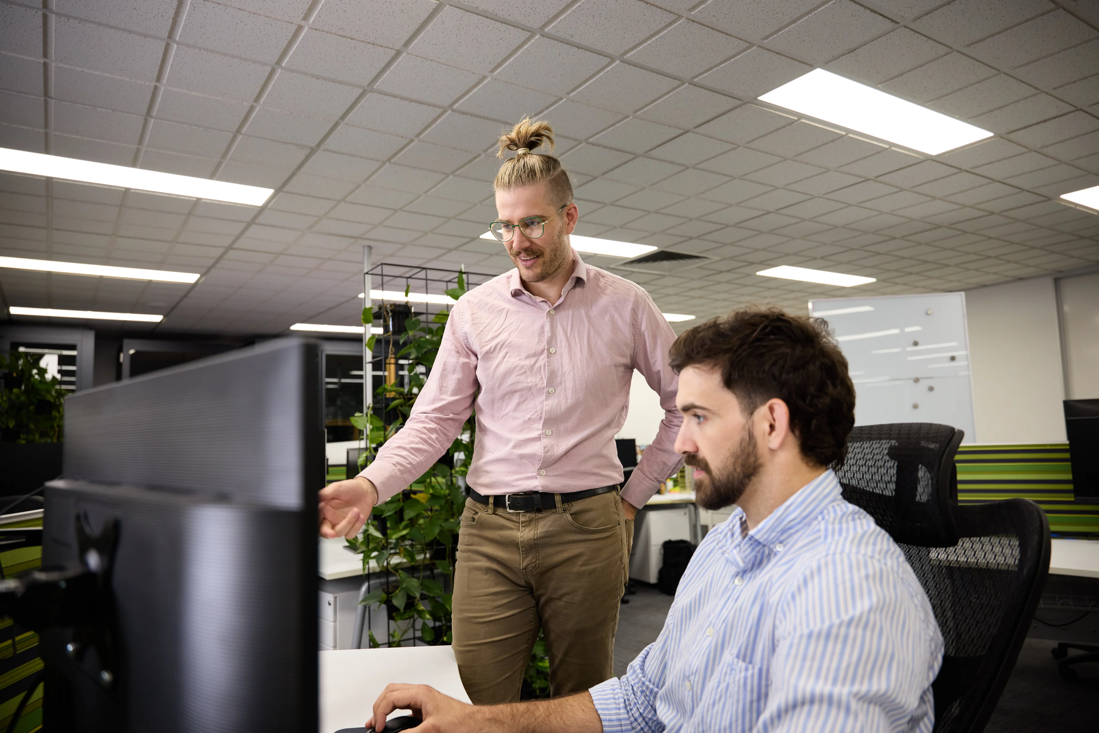 Two LINK Advance brokers reviewing a loan on screen