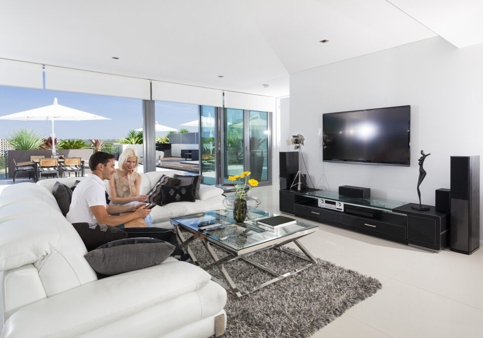 Young,Couple,Relaxing,On,Couch,In,Luxury,Living,Room