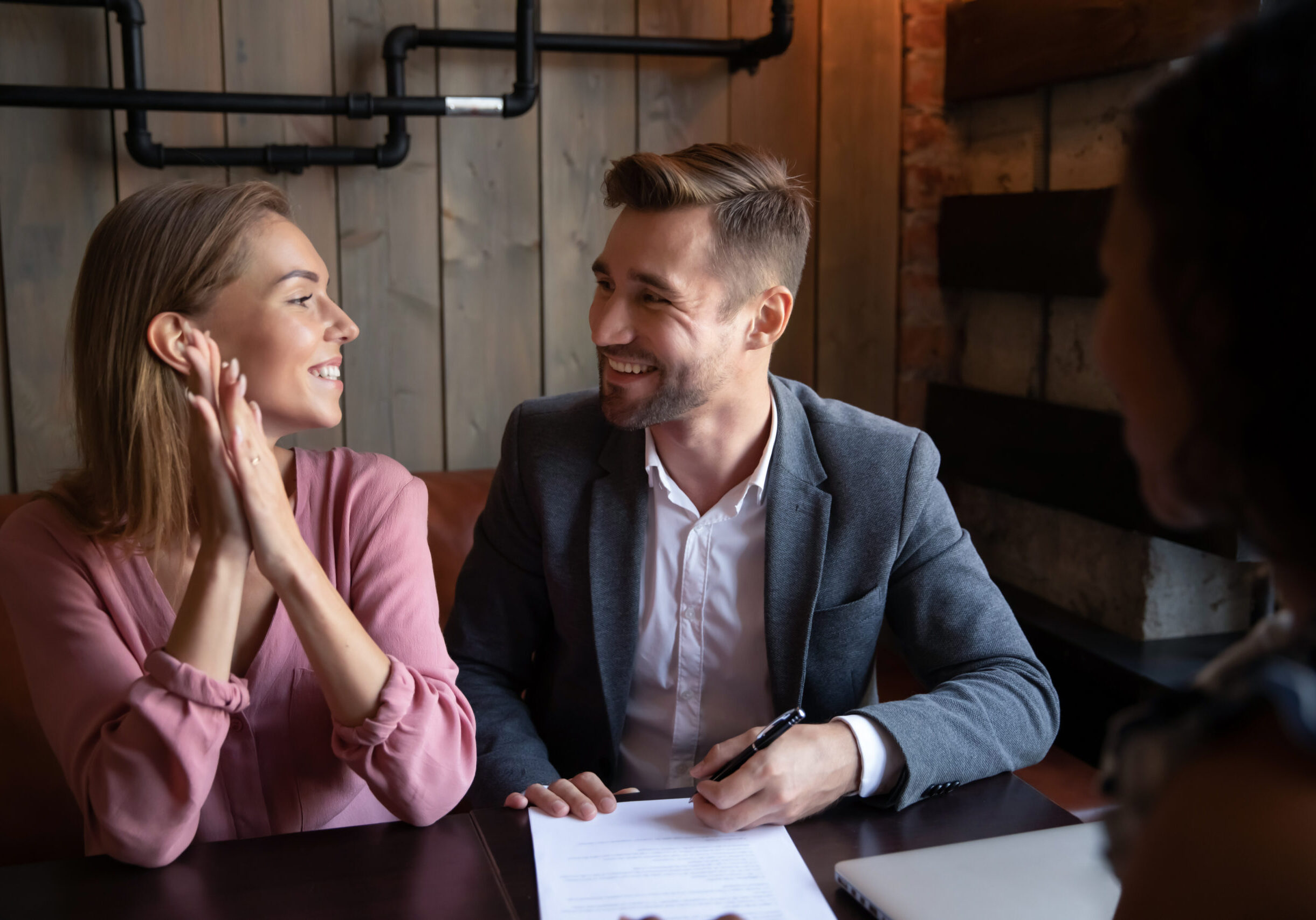 Overjoyed,Young,Couple,Sit,In,Cafe,Meeting,With,Consultant,Or