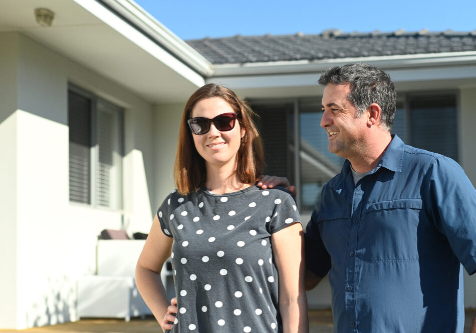 Happy,Husband,And,Wife,(age,35-45),Standing,In,Front,Of