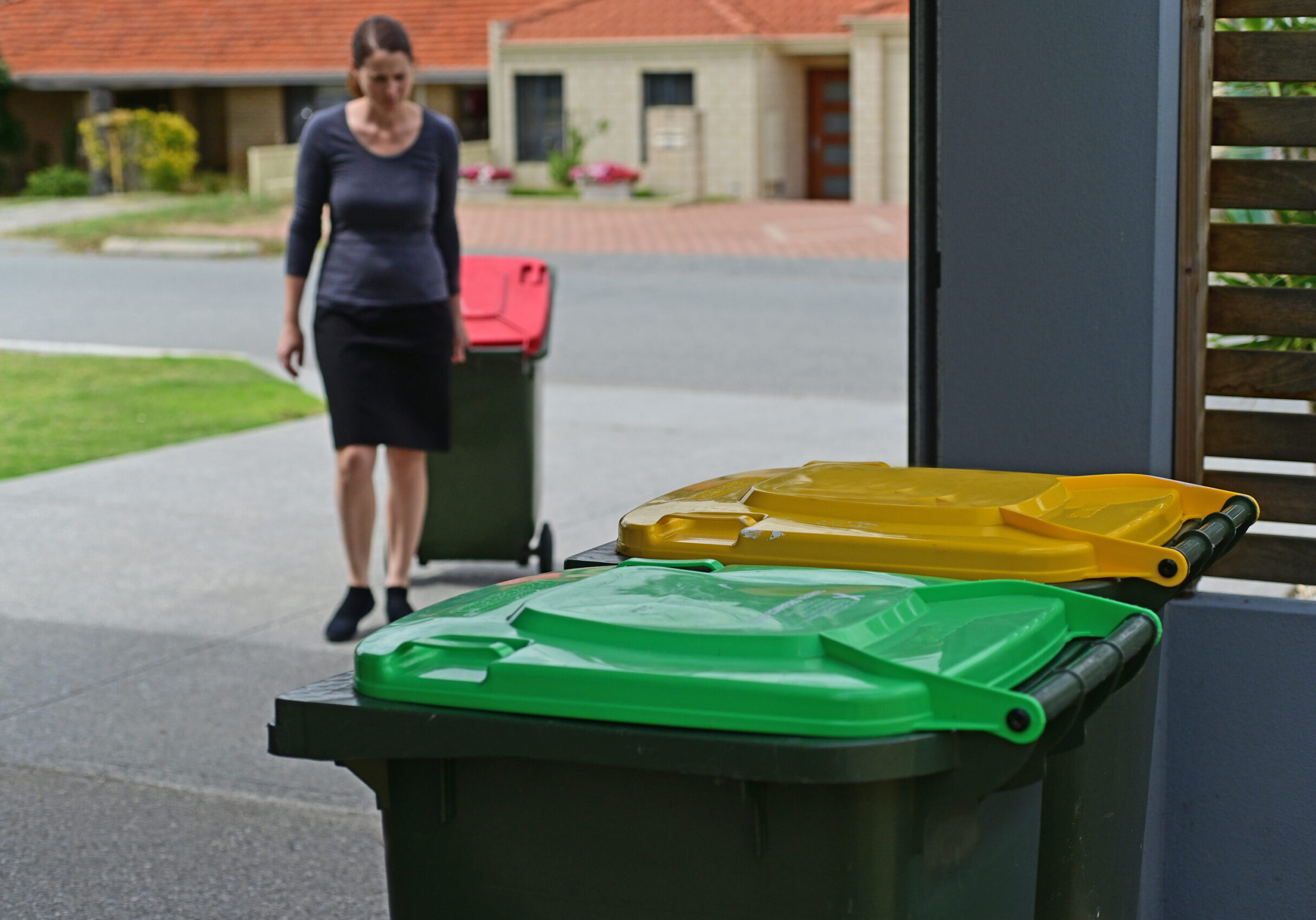 Adult,Woman,Collecting,Rubbish,Bin,From,Road,Side,On,Rubbish